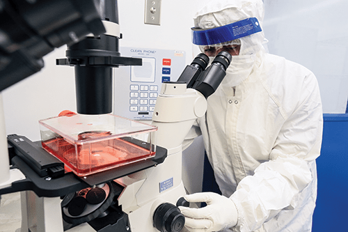 Team members in the Cell Manipulations Laboratory must wear sterile suits while they prepare gene-corrected stem cells for blood or bone marrow transplants.